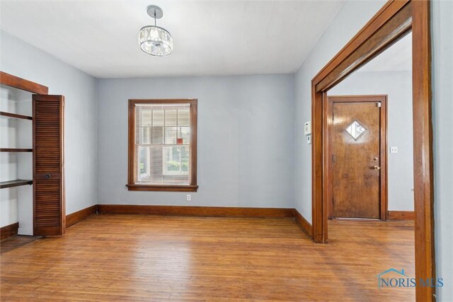 2000 Oakwood Ave, Toledo, OH 43607 - entryway featuring wood finished floors, baseboards, and a notable chandelier