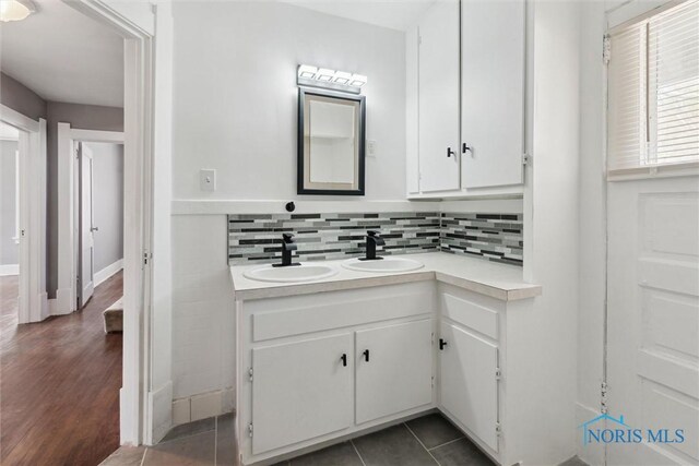2000 Oakwood Ave, Toledo, OH 43607 - bathroom featuring decorative backsplash, vanity, and wood finished floors