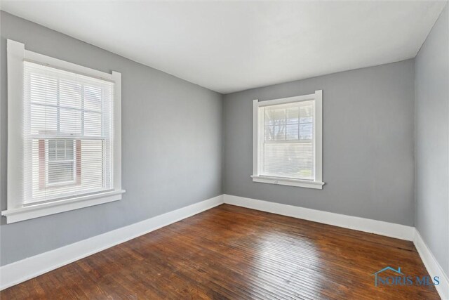 2000 Oakwood Ave, Toledo, OH 43607 - unfurnished room with dark wood finished floors and baseboards