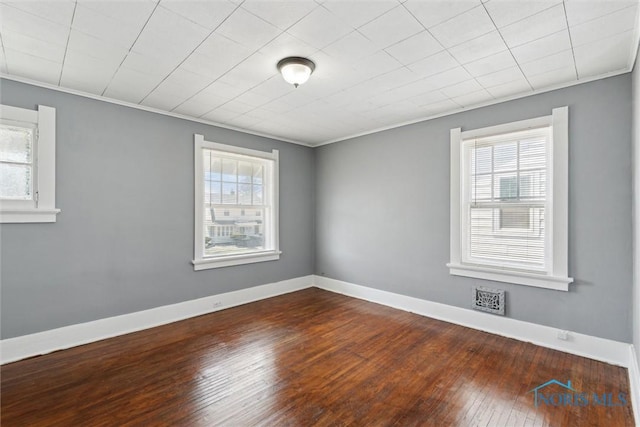 2000 Oakwood Ave, Toledo, OH 43607 - unfurnished room with dark wood finished floors, visible vents, crown molding, and baseboards
