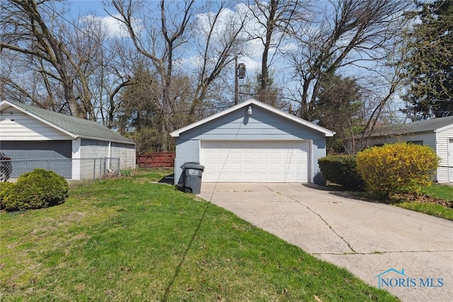 2000 Oakwood Ave, Toledo, OH 43607 - view of property exterior with a garage, a lawn, fence, and an outdoor structure