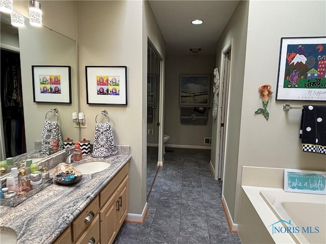 full bathroom with recessed lighting, toilet, a bath, vanity, and baseboards
