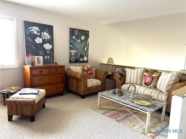 carpeted living area featuring vaulted ceiling