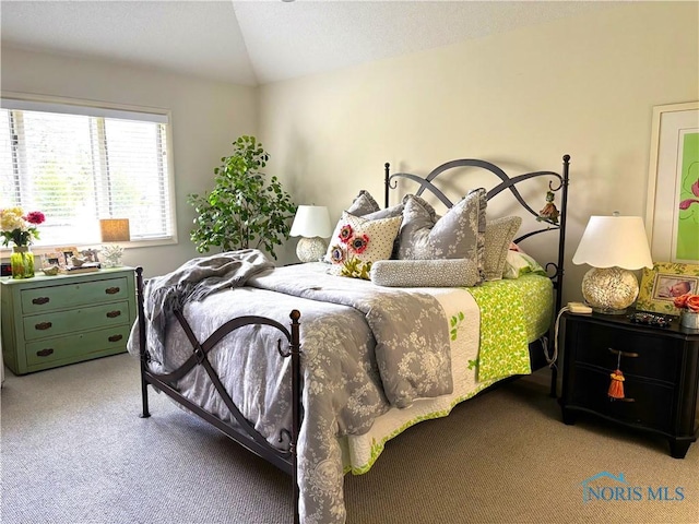 carpeted bedroom with vaulted ceiling