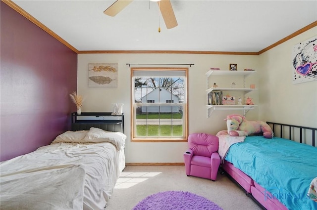 carpeted bedroom with a ceiling fan, baseboards, and ornamental molding
