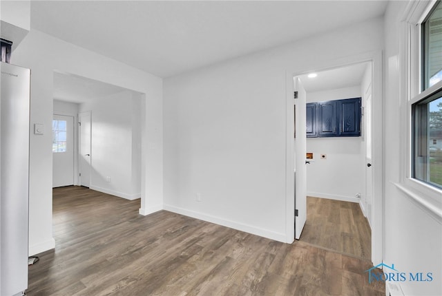 spare room featuring wood finished floors and baseboards