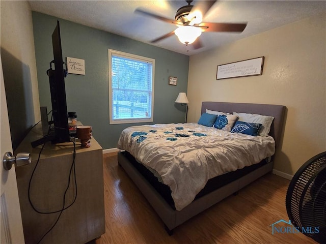 713 E Crocker St, Bradner, OH 43406 - bedroom featuring ceiling fan, baseboards, and wood finished floors