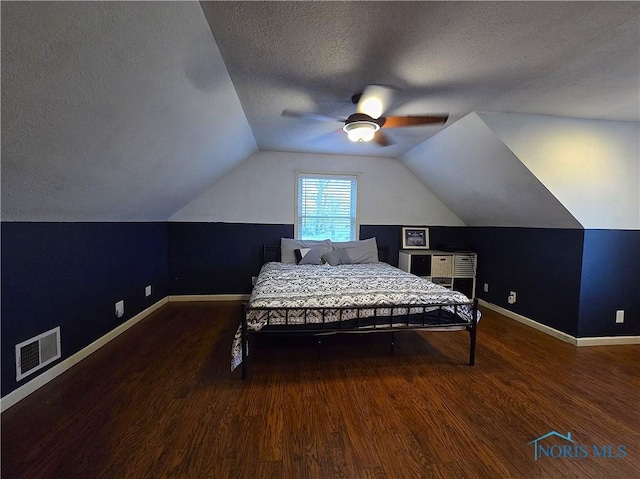 713 E Crocker St, Bradner, OH 43406 - bedroom featuring wood finished floors, a textured ceiling, baseboards, lofted ceiling, and visible vents