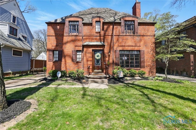 3122 Hopewell Pl, Toledo, OH 43606 - french provincial home featuring a front yard, a chimney, and brick siding