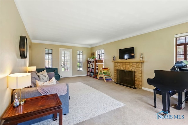3122 Hopewell Pl, Toledo, OH 43606 - living room with ornamental molding, a wealth of natural light, carpet floors, and a stone fireplace