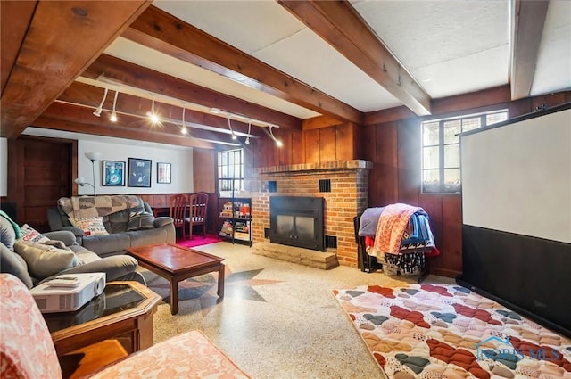 3122 Hopewell Pl, Toledo, OH 43606 - living area with beam ceiling, a wealth of natural light, wooden walls, and a brick fireplace