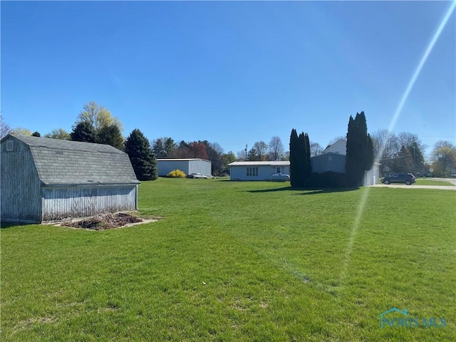 view of yard with a storage shed and an outbuilding