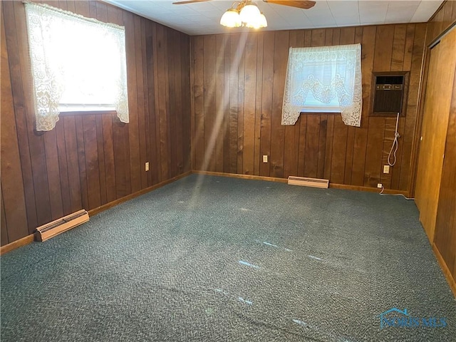 empty room with carpet flooring, a wealth of natural light, a ceiling fan, and a wall unit AC