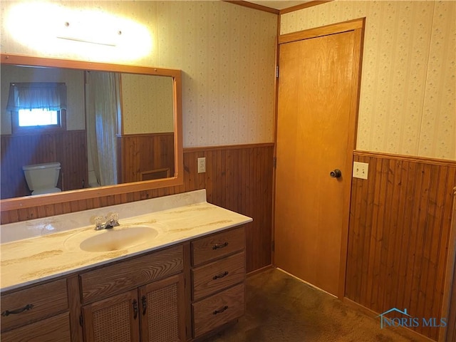 bathroom featuring wallpapered walls, a wainscoted wall, and wood walls