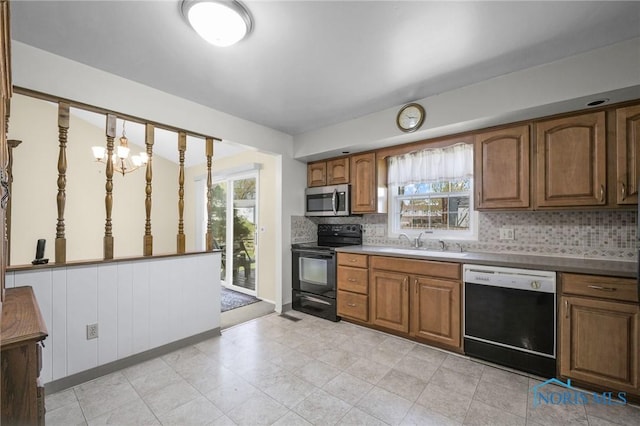 kitchen featuring stainless steel microwave, a sink, electric range, dishwashing machine, and brown cabinetry