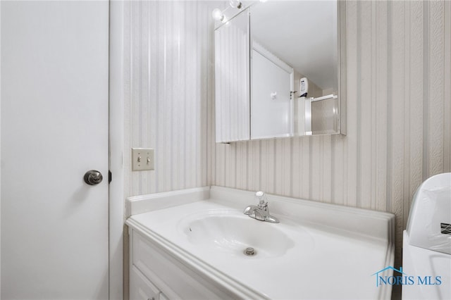 bathroom with vanity and washer / clothes dryer