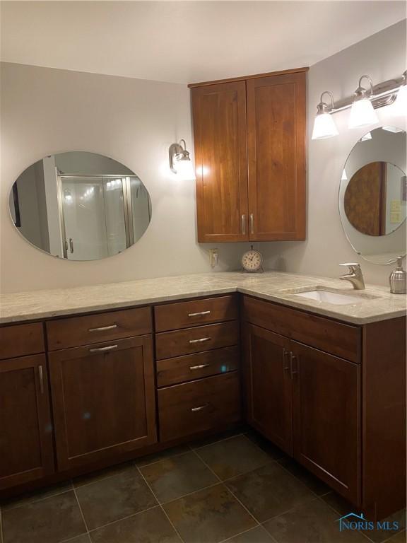 bathroom with tile patterned floors and vanity