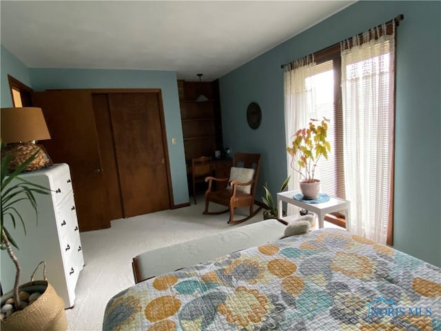bedroom featuring light carpet and a closet