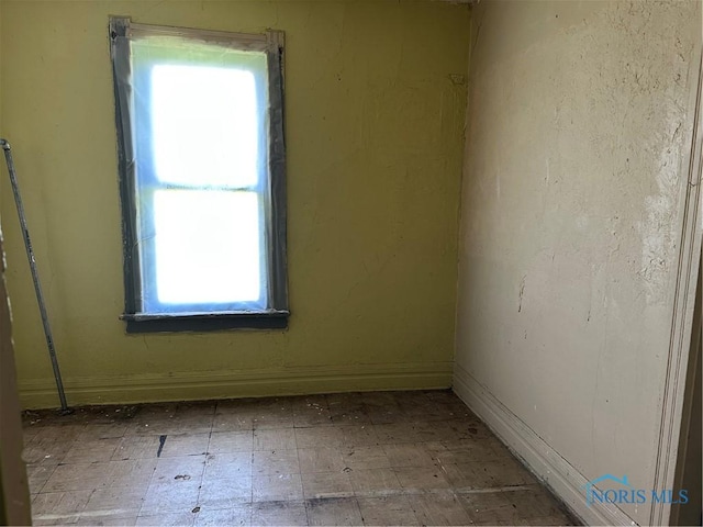 1331 Grand Ave, Toledo, OH 43606 - empty room featuring tile patterned floors and a healthy amount of sunlight