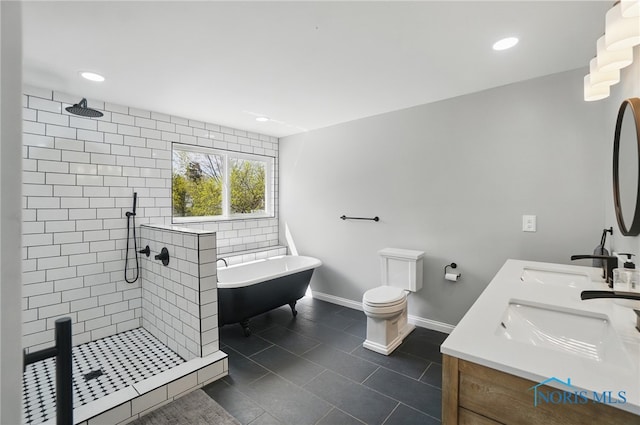 bathroom featuring a tile shower, double vanity, a sink, baseboards, and a soaking tub