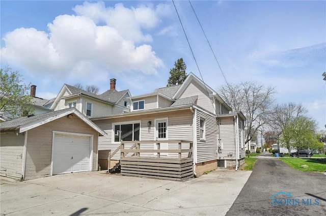 view of front of home featuring a deck and concrete driveway