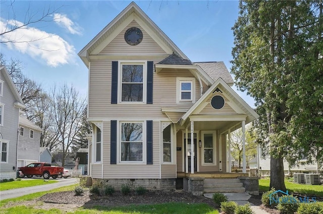 view of front of house with a shingled roof and covered porch