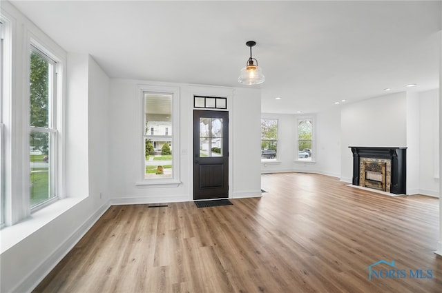 entrance foyer featuring visible vents, baseboards, wood finished floors, and recessed lighting