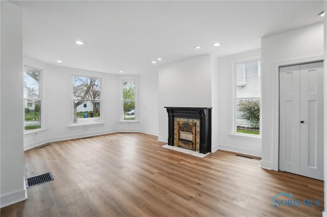 unfurnished living room with wood finished floors, visible vents, and recessed lighting
