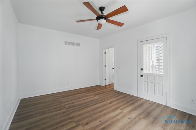 unfurnished bedroom featuring wood finished floors, visible vents, baseboards, and ceiling fan
