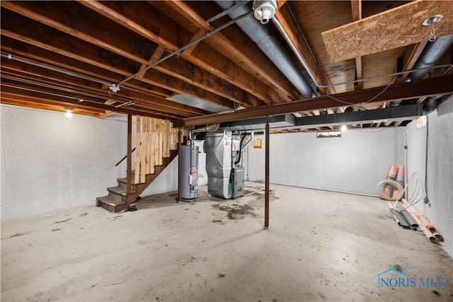 1705 Archwood Ln, Toledo, OH 43614 - unfinished below grade area with heating unit, gas water heater, and stairway
