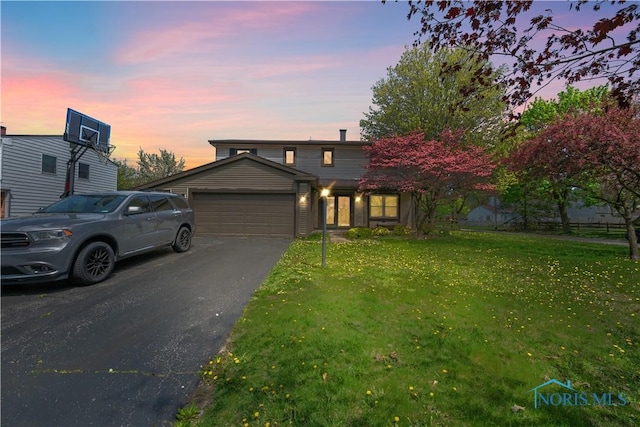 1705 Archwood Ln, Toledo, OH 43614 - traditional-style home featuring a garage, a front lawn, and driveway