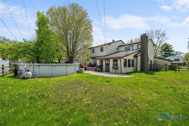1705 Archwood Ln, Toledo, OH 43614 - rear view of property featuring fence private yard, a lawn, and an outdoor pool