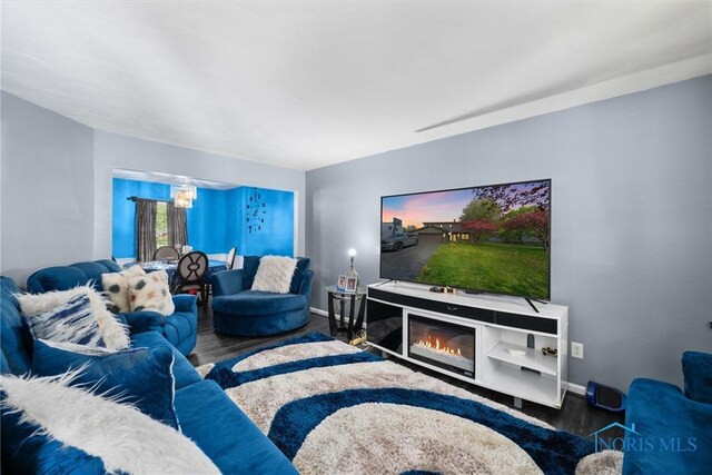 1705 Archwood Ln, Toledo, OH 43614 - living room featuring baseboards, a notable chandelier, and wood finished floors
