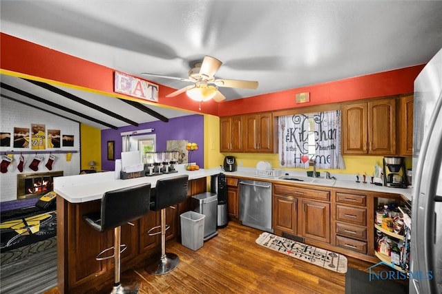 1705 Archwood Ln, Toledo, OH 43614 - kitchen featuring brown cabinets, light countertops, stainless steel appliances, a ceiling fan, and a peninsula