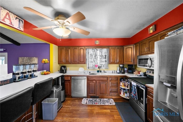 1705 Archwood Ln, Toledo, OH 43614 - kitchen featuring ceiling fan, dark wood-style flooring, appliances with stainless steel finishes, a sink, and light countertops
