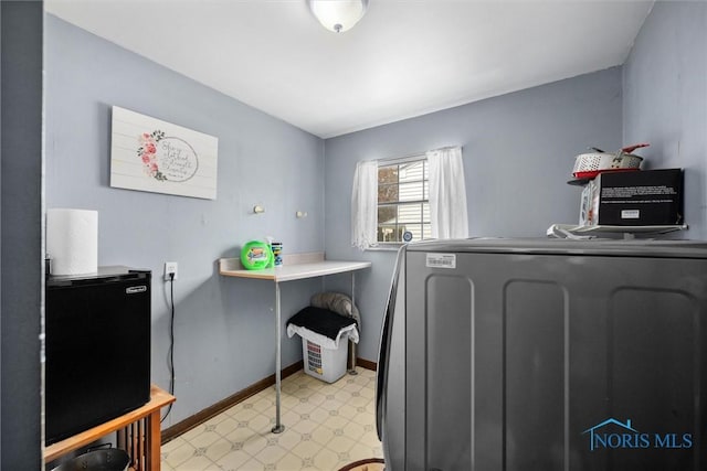 1705 Archwood Ln, Toledo, OH 43614 - laundry room featuring baseboards, laundry area, light floors, and separate washer and dryer