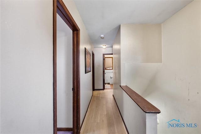 1705 Archwood Ln, Toledo, OH 43614 - hall featuring light wood-style floors, baseboards, and an upstairs landing
