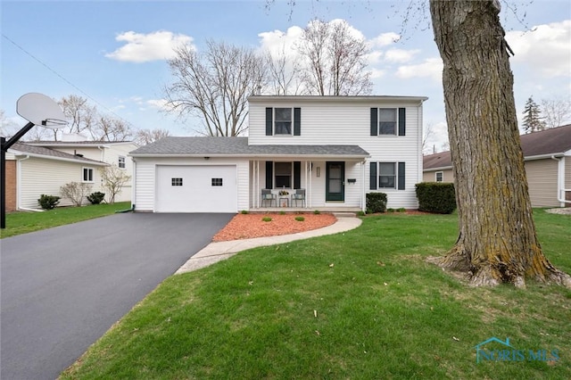 traditional-style house with an attached garage, aphalt driveway, a porch, and a front yard