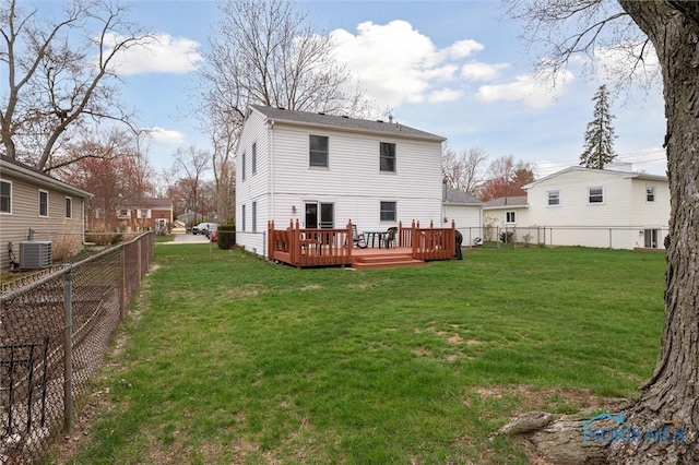 back of house with a wooden deck, a yard, cooling unit, and a fenced backyard
