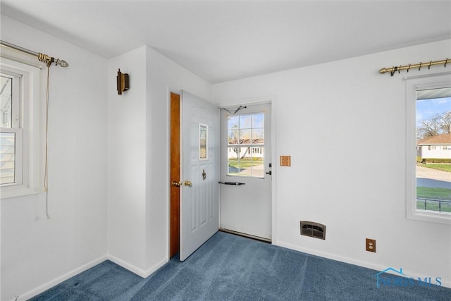 5148 Fern Dr, Toledo, OH 43613 - doorway to outside featuring baseboards and dark carpet
