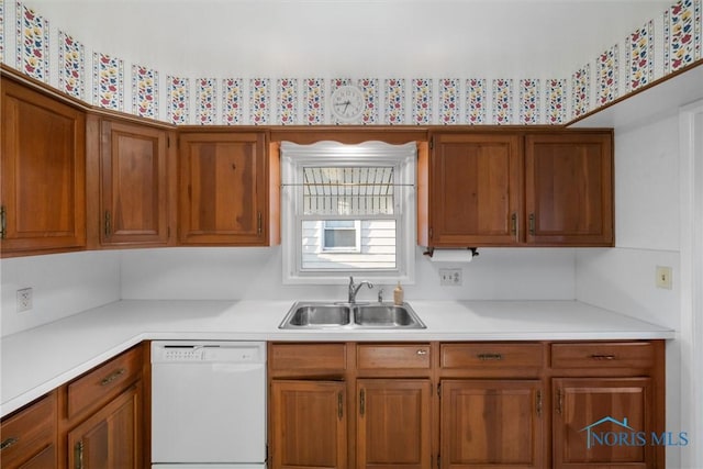 5148 Fern Dr, Toledo, OH 43613 - kitchen featuring white dishwasher, light countertops, brown cabinetry, and a sink