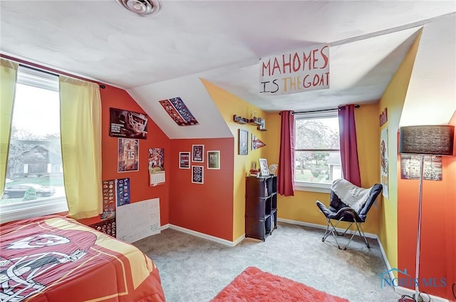carpeted bedroom with baseboards, visible vents, and lofted ceiling