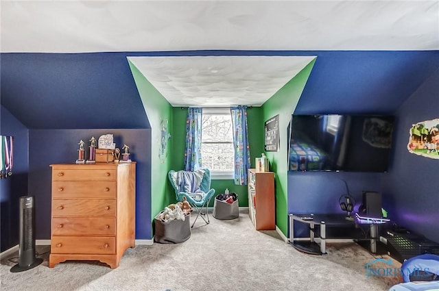 interior space featuring carpet, vaulted ceiling, and baseboards