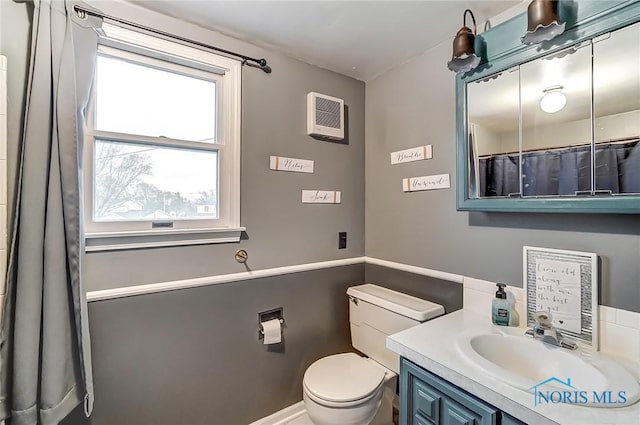 bathroom featuring toilet and vanity