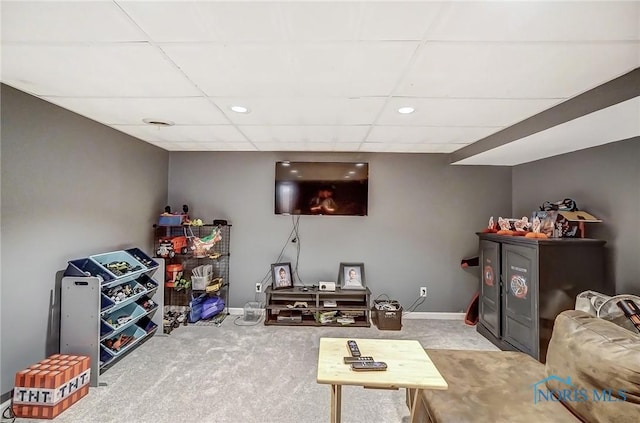 living room featuring baseboards, recessed lighting, carpet floors, and a paneled ceiling