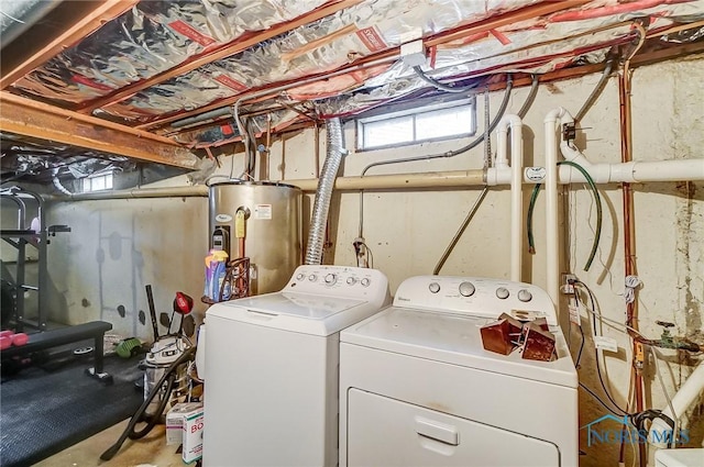 clothes washing area featuring water heater, laundry area, and independent washer and dryer