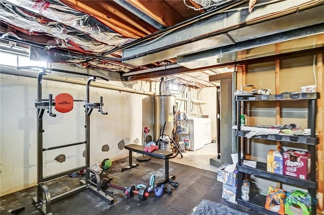 exercise room with water heater and washer / clothes dryer