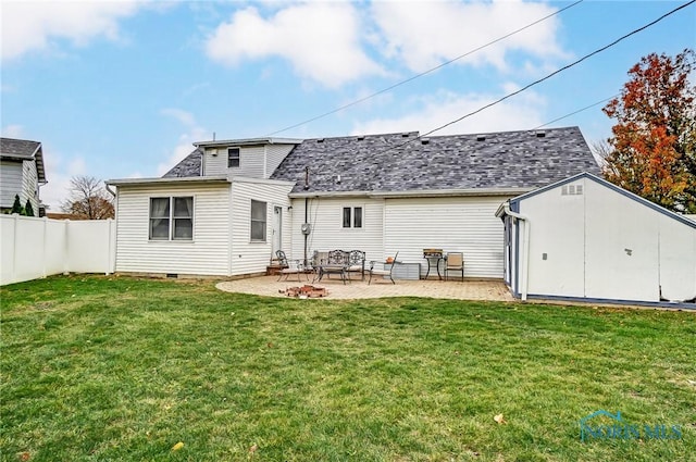 back of property featuring fence, a lawn, a patio, and a shingled roof