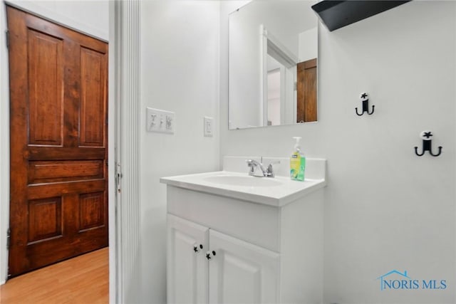 bathroom with vanity and wood finished floors