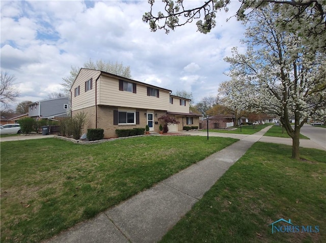 view of front of home featuring brick siding and a front yard